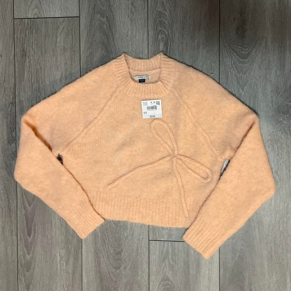 AE Cropped Crew Neck Bow Sweater. 
Peach color. (Looks like model pic)